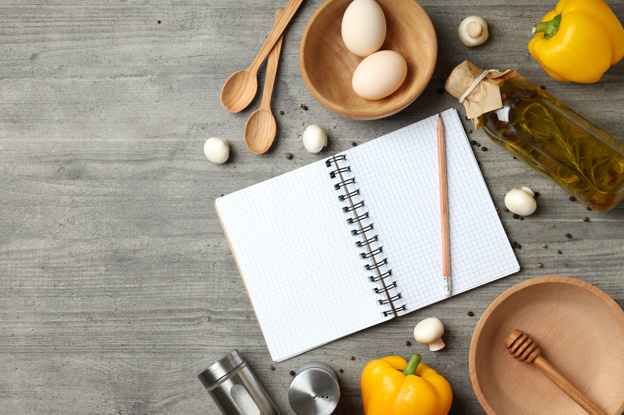 Flat lay of cooking tools and notebook